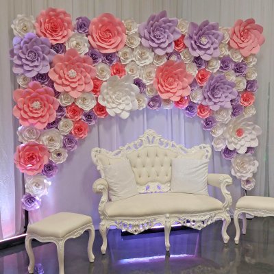 Backdrop partially filled with the paper flowers.